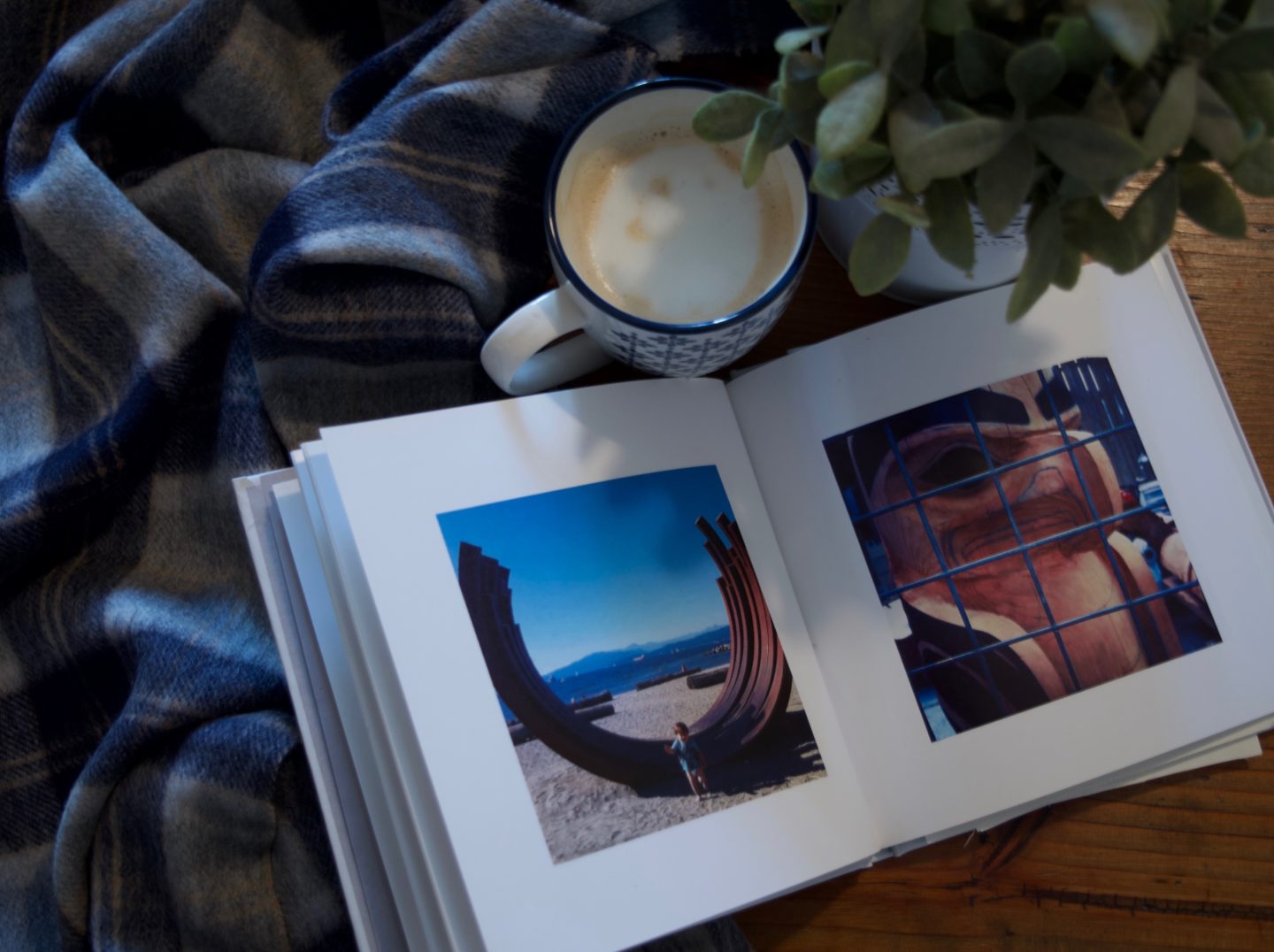 One of my many travel photo books... my son loves looking at them. And yes, that's my cozy Tartan Blanket Co. scarf there too