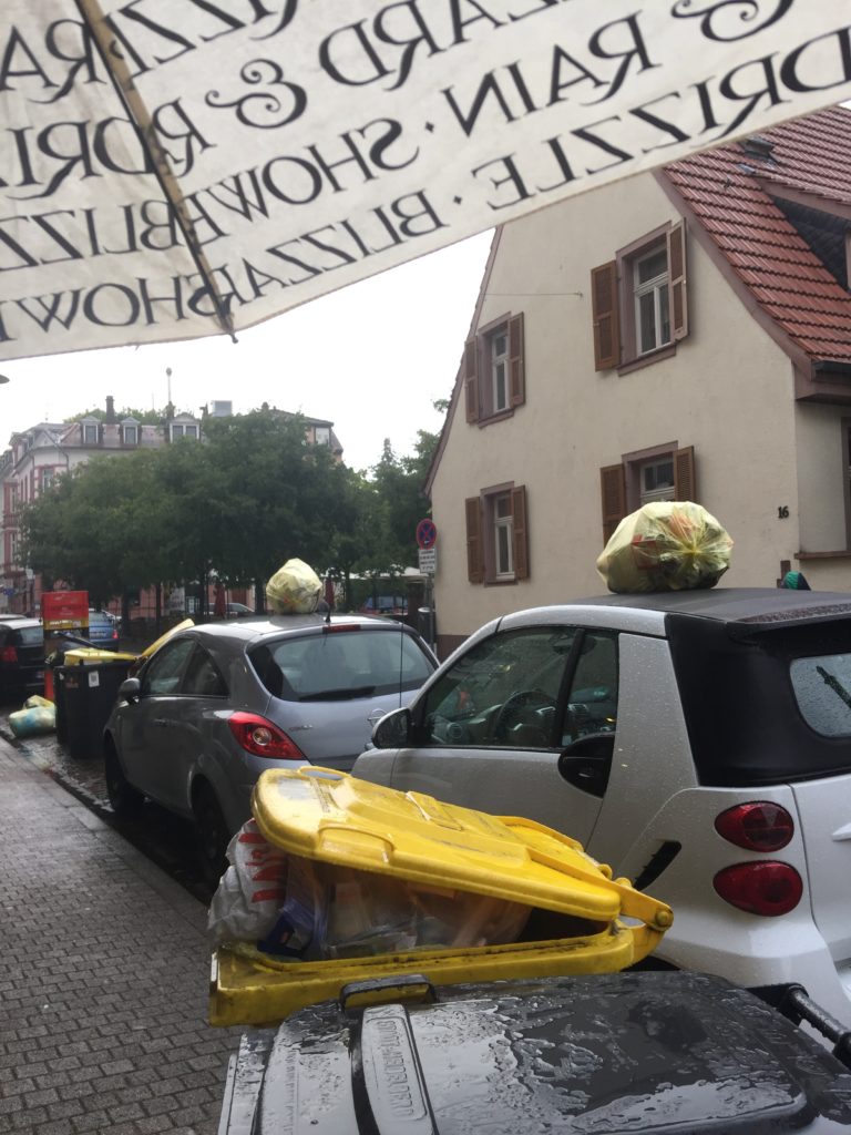 When there's no room for your recycling on the narrow German streets, plop the bag on top of a car. 