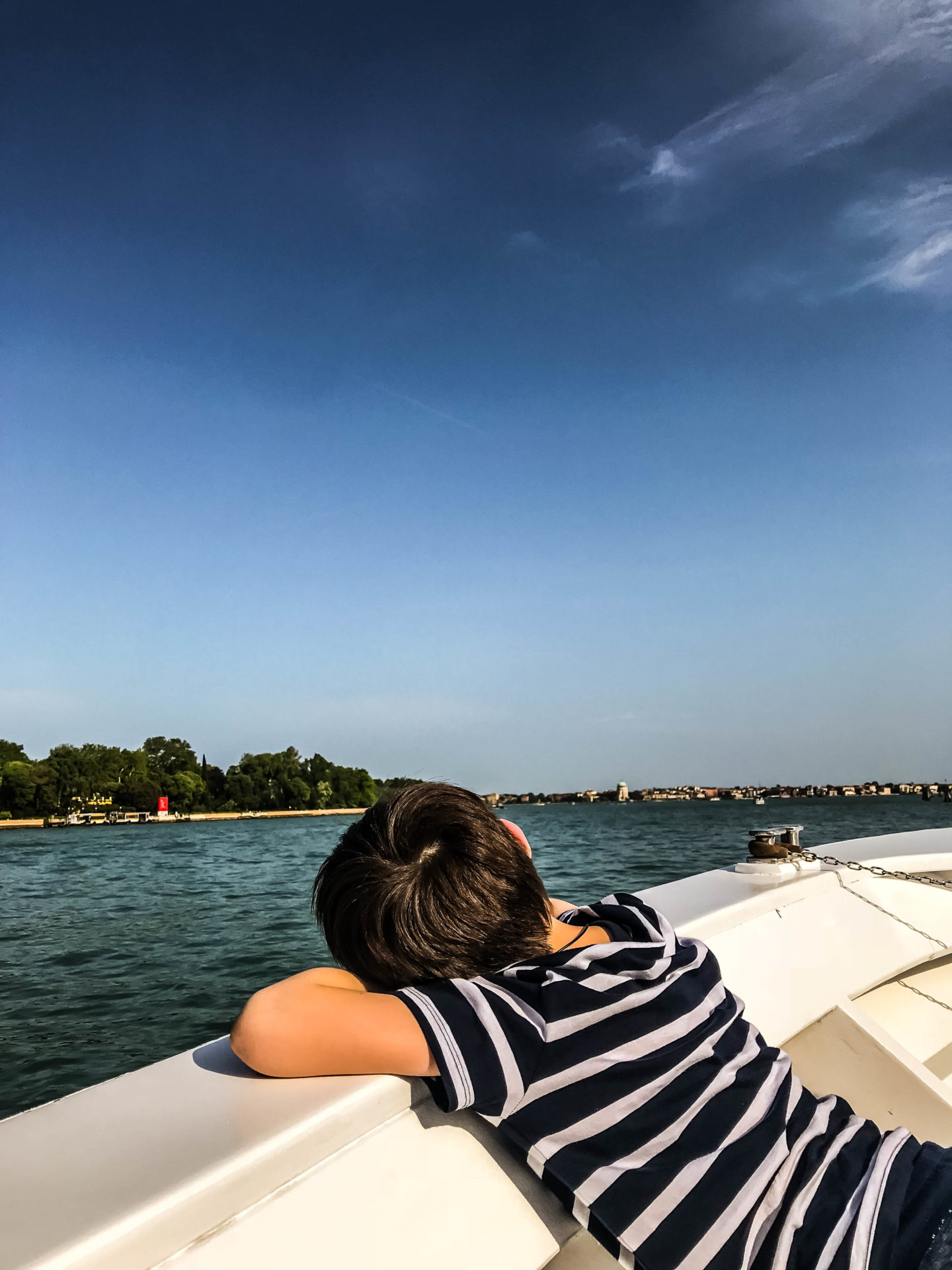 My son relaxing on the boat ride back from Venice