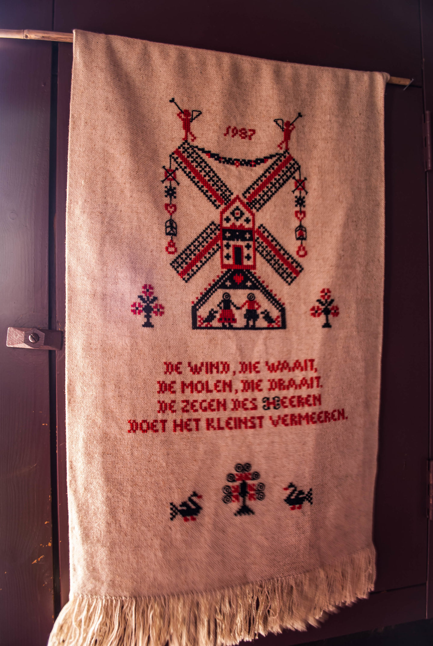Embroidery hanging in one of the windmills. Rough translation: 'The wind that blows, the mill that turns, the blessing of the Lord that makes the small increase.'